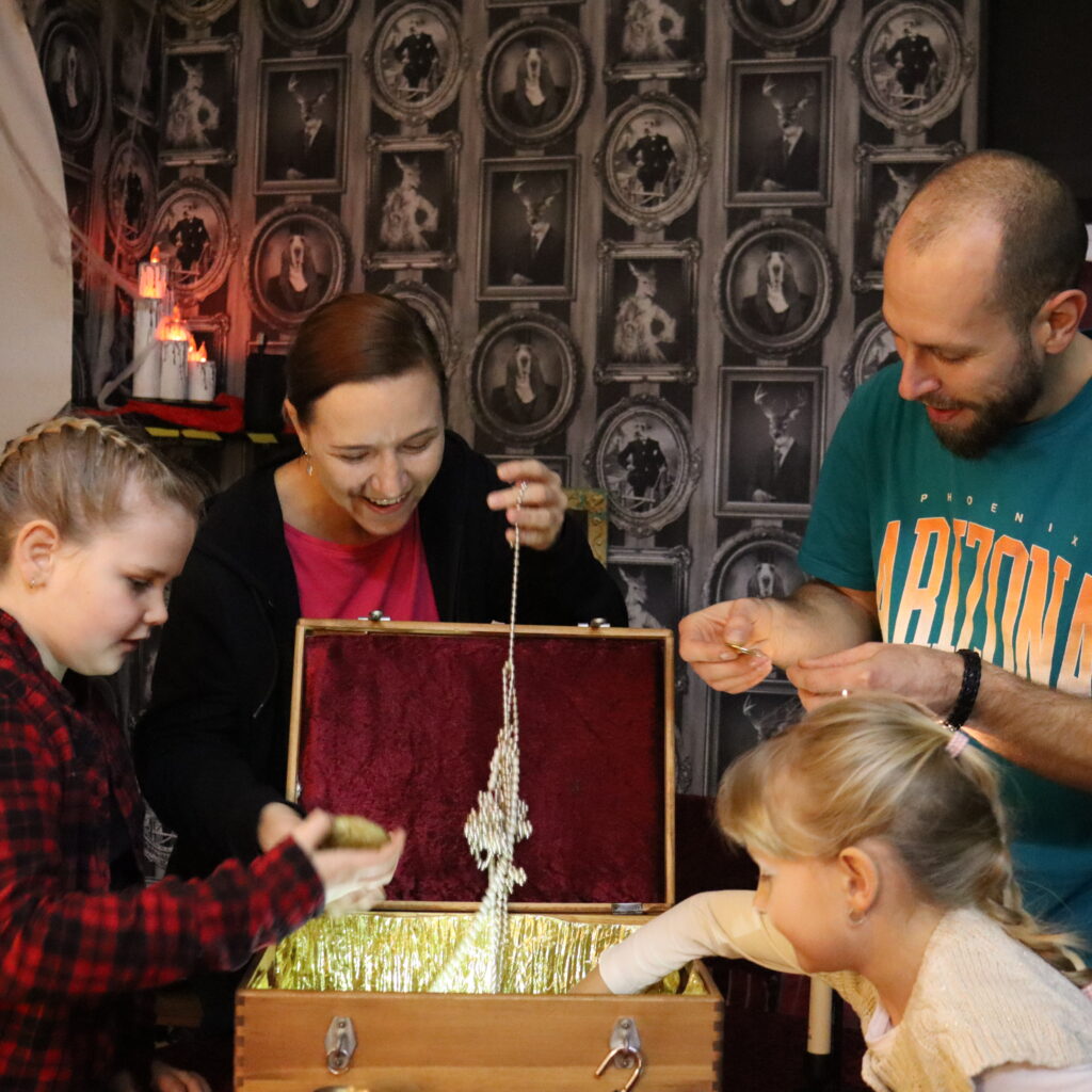 Rodina s deťmi rieši úlohu v detskej escape room počas hry v LeavingRoom Bratislava